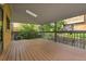 Covered outdoor deck with wood floors and railing, perfect for relaxing and entertaining at 10222 W Ida Ave # 237, Littleton, CO 80127
