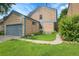 View of a home exterior, showing a well-kept lawn, garden, and attached garage at 10222 W Ida Ave # 237, Littleton, CO 80127