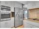 Modern kitchen with stainless steel appliances and white cabinetry at 10222 W Ida Ave # 237, Littleton, CO 80127