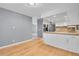 Open-concept with living room and kitchen featuring modern appliances and white cabinets at 10222 W Ida Ave # 237, Littleton, CO 80127