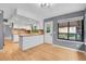 Open kitchen with stone countertops, white cabinets, and hardwood floors at 10222 W Ida Ave # 237, Littleton, CO 80127