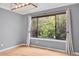 Bright and airy living room with hardwood floors and a large window at 10222 W Ida Ave # 237, Littleton, CO 80127