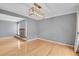 Open living room with hardwood floors, fireplace, and modern light fixture at 10222 W Ida Ave # 237, Littleton, CO 80127