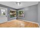 Bright living room features hardwood floors and large windows with neighborhood views at 10222 W Ida Ave # 237, Littleton, CO 80127