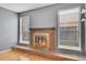Living room with a brick fireplace and large windows letting in natural light at 10222 W Ida Ave # 237, Littleton, CO 80127