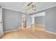 Open living room with hardwood floors, modern lighting, and access to the kitchen at 10222 W Ida Ave # 237, Littleton, CO 80127