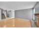 Spacious living room with hardwood floors, fireplace, and staircase access at 10222 W Ida Ave # 237, Littleton, CO 80127
