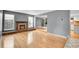 Cozy living room with a brick fireplace, hardwood floors, and lots of natural light at 10222 W Ida Ave # 237, Littleton, CO 80127