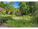 Scenic view of the pond surrounded by greenery and trees, offering a serene community space at 10222 W Ida Ave # 237, Littleton, CO 80127