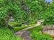 Scenic community pond with waterfall feature, lush landscaping, and seating at 10222 W Ida Ave # 237, Littleton, CO 80127