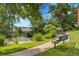 Beautiful pond view with lush greenery and a tranquil bench to relax by the water at 10222 W Ida Ave # 237, Littleton, CO 80127