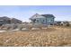 Large backyard with a retaining wall and grassy area at 528 Nesting Eagles Way, Berthoud, CO 80513