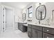 Elegant bathroom with double vanity, modern fixtures and a large mirror at 528 Nesting Eagles Way, Berthoud, CO 80513