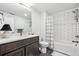 Modern bathroom with dark vanity, white subway tile, and bathtub at 528 Nesting Eagles Way, Berthoud, CO 80513