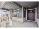 Inviting front porch with stone accents and a double door entry at 528 Nesting Eagles Way, Berthoud, CO 80513