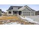 Two-story home with gray siding, stone accents, and a two-car garage at 528 Nesting Eagles Way, Berthoud, CO 80513