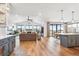 Open concept kitchen with an island and gray cabinets at 528 Nesting Eagles Way, Berthoud, CO 80513