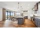 Modern kitchen with island, stainless steel appliances, and hardwood floors at 528 Nesting Eagles Way, Berthoud, CO 80513