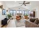 Vaulted living room with hardwood floors, fireplace, and large windows at 528 Nesting Eagles Way, Berthoud, CO 80513