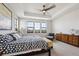 Spacious main bedroom with a ceiling fan and large windows at 528 Nesting Eagles Way, Berthoud, CO 80513