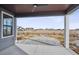 Covered patio overlooking a spacious backyard and neighboring homes at 528 Nesting Eagles Way, Berthoud, CO 80513