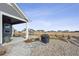 Stone patio with grill and view of the backyard and neighborhood at 528 Nesting Eagles Way, Berthoud, CO 80513