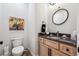 Modern powder room with light wood vanity and a dark countertop at 528 Nesting Eagles Way, Berthoud, CO 80513