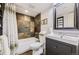 Bathroom featuring patterned tile shower and backsplash, modern vanity and fixtures, and neutral decor at 5572 Fullerton Cir, Highlands Ranch, CO 80130