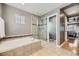 This bathroom boasts a large tub, a glass shower, tiled flooring, and neutral-colored walls at 5572 Fullerton Cir, Highlands Ranch, CO 80130