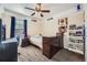 This bedroom offers carpeted floors, a ceiling fan, a window, and a dresser at 5572 Fullerton Cir, Highlands Ranch, CO 80130