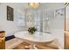 Bright breakfast nook featuring bench seating and a white wooden table at 5572 Fullerton Cir, Highlands Ranch, CO 80130