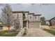 Charming two-story home features a stone-accented facade and attached two-car garage at 5572 Fullerton Cir, Highlands Ranch, CO 80130