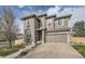 Charming two-story home features a stone-accented facade and attached two-car garage at 5572 Fullerton Cir, Highlands Ranch, CO 80130
