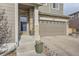 A close up of the front entryway and attached two-car garage of this charming home at 5572 Fullerton Cir, Highlands Ranch, CO 80130