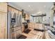 Modern kitchen boasts stainless steel appliances, wooden cabinets and stone countertops at 5572 Fullerton Cir, Highlands Ranch, CO 80130