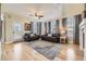 Light-filled living room with tall ceilings, hardwood floors and comfortable leather furniture at 5572 Fullerton Cir, Highlands Ranch, CO 80130