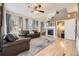 Spacious living room with a fireplace, large windows, and hardwood floors at 5572 Fullerton Cir, Highlands Ranch, CO 80130