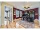 This office offers hardwood floors, built-in shelves, 3 guitars, and burgundy painted walls at 5572 Fullerton Cir, Highlands Ranch, CO 80130