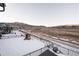 Snowy backyard with mountain views and a playset at 15601 W Eureka Ave, Morrison, CO 80465