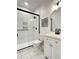 Clean bathroom with white vanity, black accents, and a tiled shower at 15601 W Eureka Ave, Morrison, CO 80465