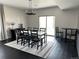 Modern dining area with a black and white table, chairs, and a chandelier at 15601 W Eureka Ave, Morrison, CO 80465