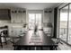 Kitchen dining area with large dark wood table and sliding glass door at 15601 W Eureka Ave, Morrison, CO 80465