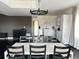 Modern dining area with a black and white table and chairs, and a chandelier at 15601 W Eureka Ave, Morrison, CO 80465