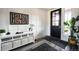 Bright entryway with modern console table and black front door at 15601 W Eureka Ave, Morrison, CO 80465