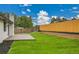 Well maintained backyard with a wooden deck, healthy grass, and a wood privacy fence at 8357 Dudley Ct, Arvada, CO 80005