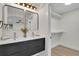 Bathroom featuring double sinks, gold fixtures, modern cabinetry and a walk in closet at 8357 Dudley Ct, Arvada, CO 80005