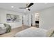 Spacious bedroom leading to a bathroom with modern fixtures and a unique painting at 8357 Dudley Ct, Arvada, CO 80005