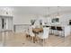 Dining area showcasing hardwood floors, elegant furniture, and modern light fixtures at 8357 Dudley Ct, Arvada, CO 80005