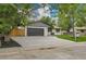 Charming single-story home featuring a large driveway, two-car garage, and inviting lawn at 8357 Dudley Ct, Arvada, CO 80005
