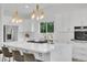 Modern kitchen boasts a large island, stainless steel appliances, and sleek finishes at 8357 Dudley Ct, Arvada, CO 80005